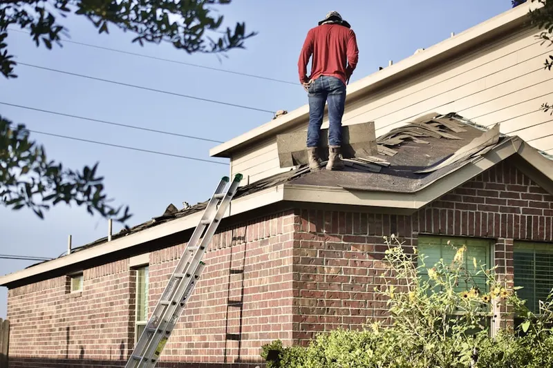 Professional roofer working on a residential roof in Heritage Park